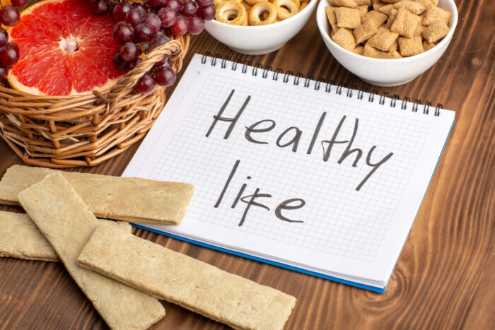 Person preparing a healthy detox meal with fruits, vegetables, and supplements representing the C9 Diet cleansing program.