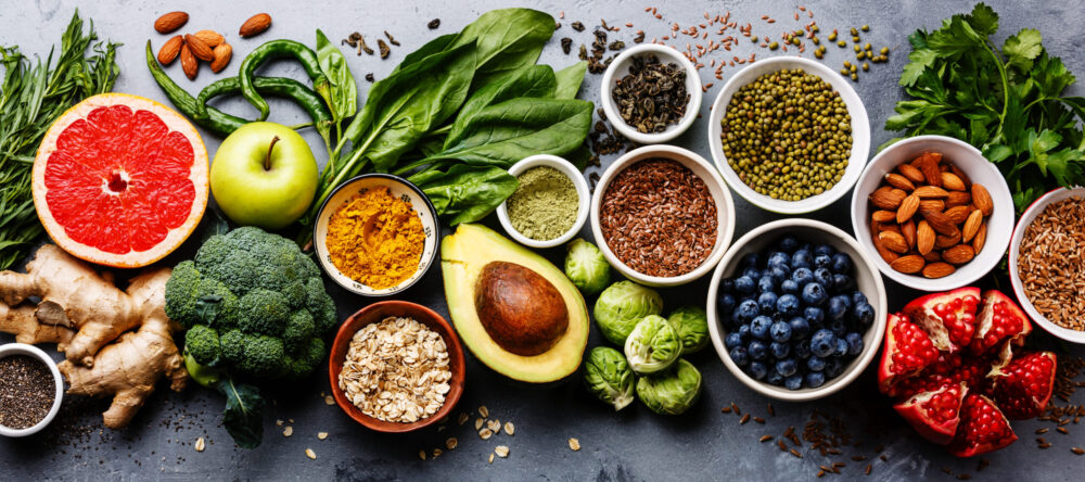 Bladder health foods including fruits, vegetables, water, and herbal tea for cystitis prevention