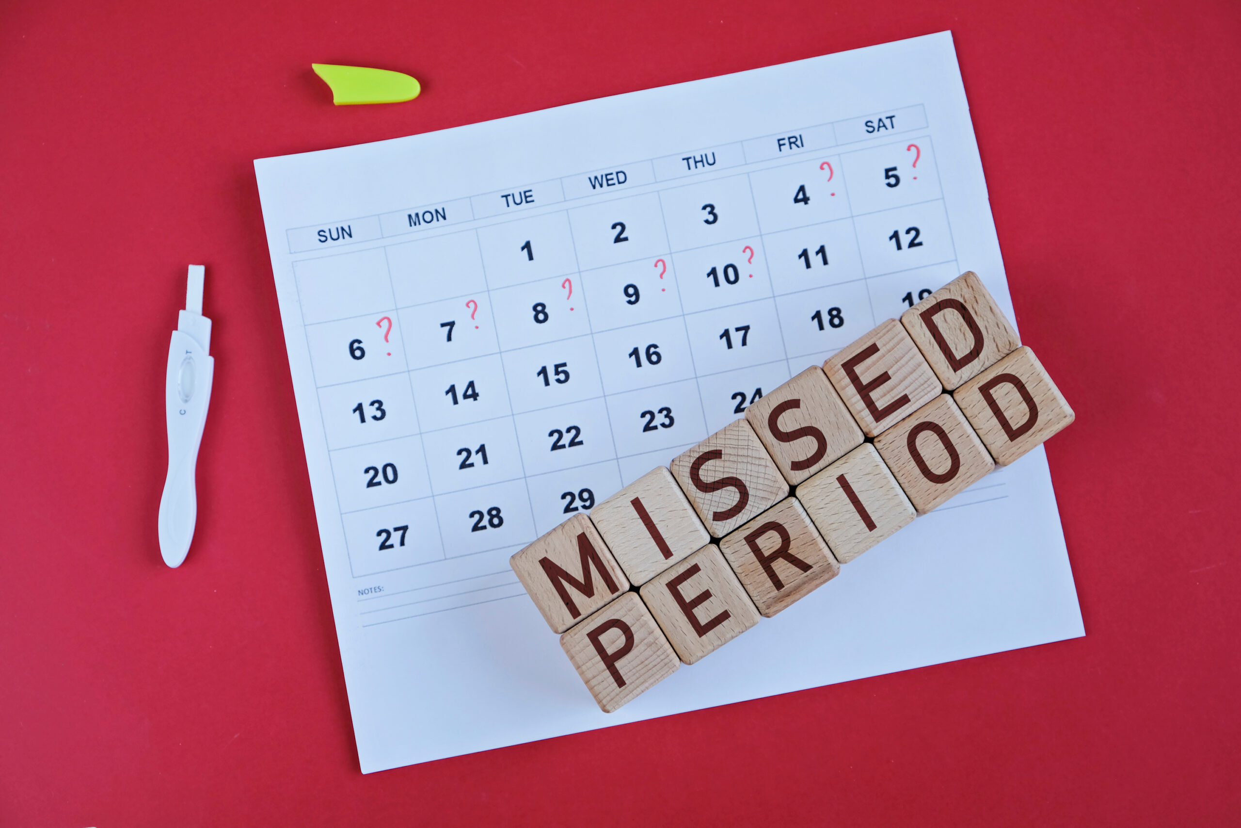 Close-up of a monthly calendar used to track menstrual cycles and missed periods.