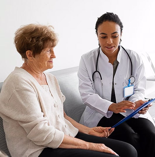 Female doctor reviewing test results with an elderly patient.