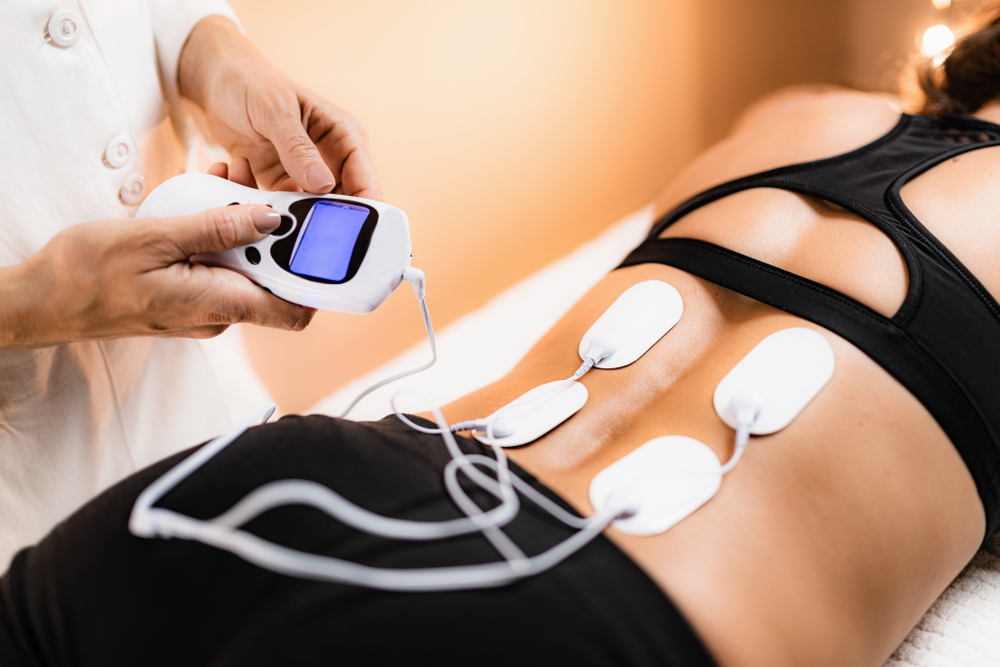 Lower back physical therapy with tens electrode pads